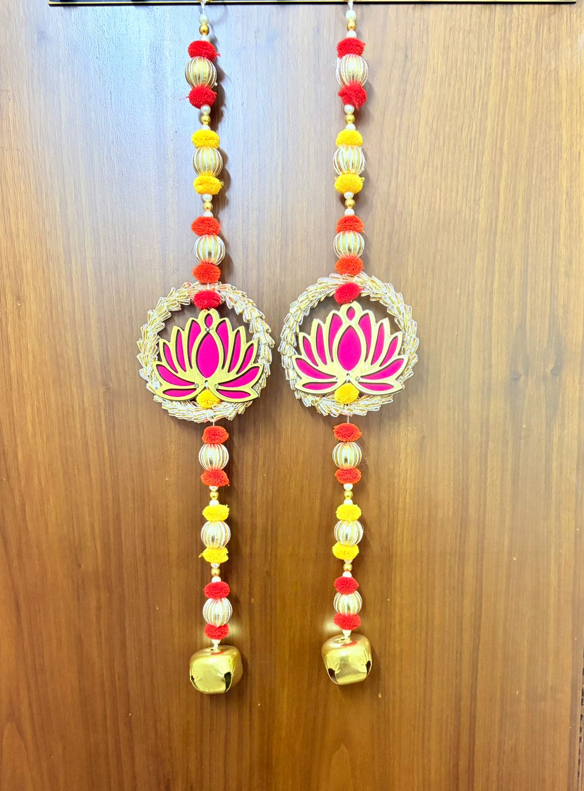 Handcrafted Pink Lotus Circular Frame Golden Bell Hanging Toran Set of 2
